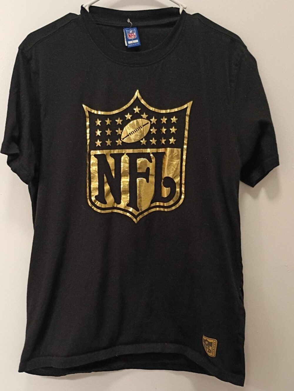 NFL Black T‑Shirt with Metallic Gold Shield Logo